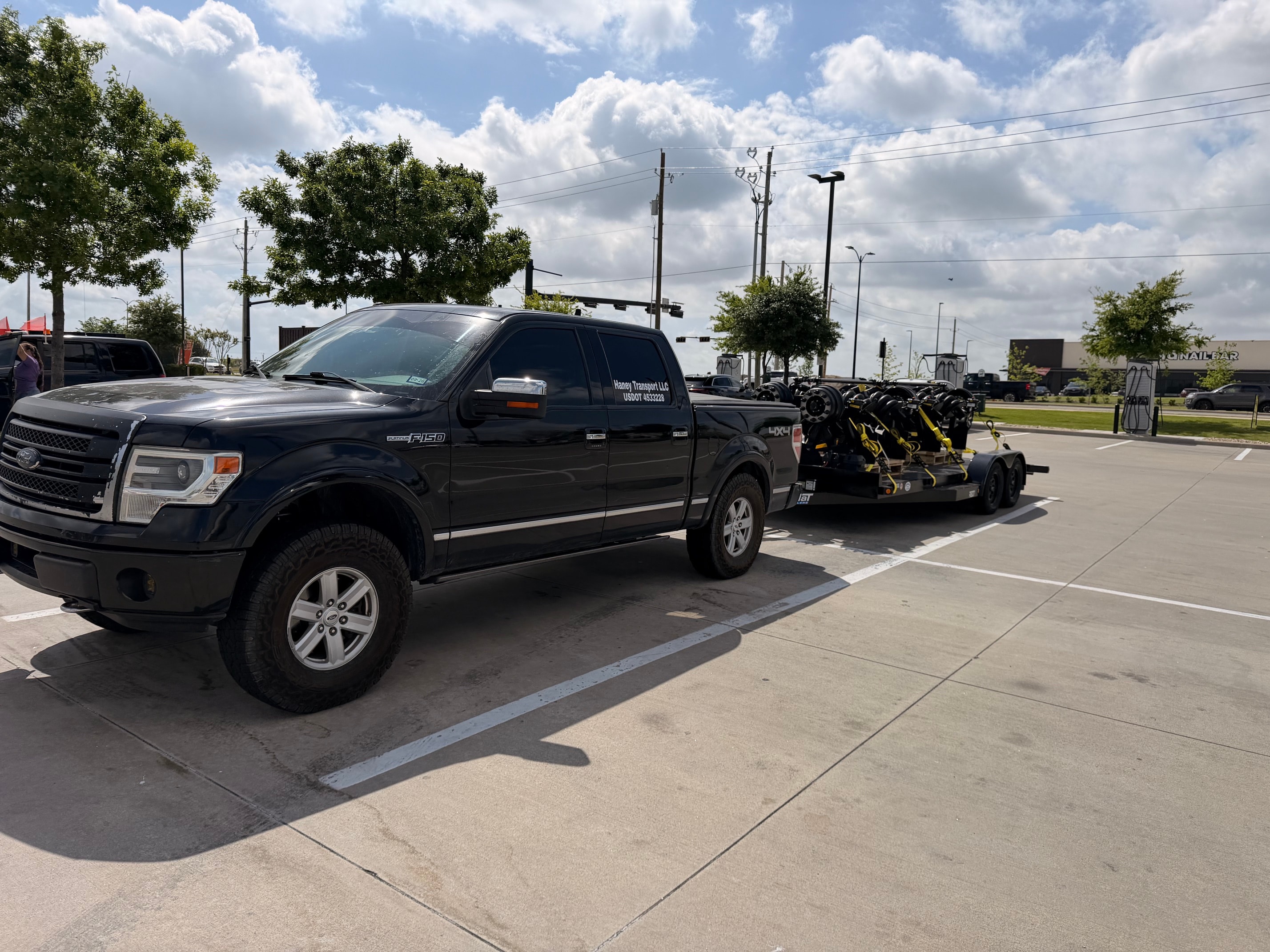 Haney Transport F-150 hauling equipment on trailer