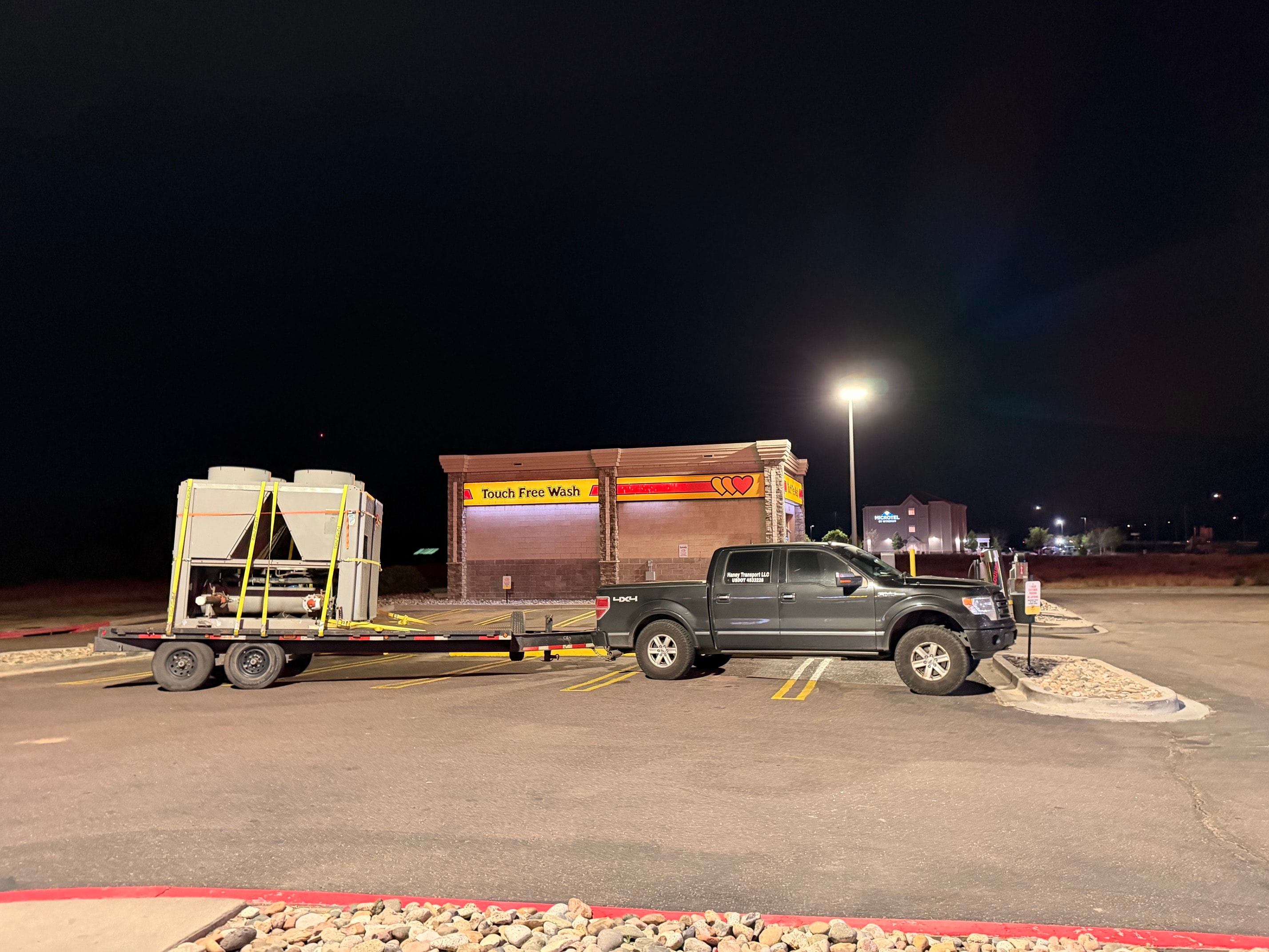Haney Transport truck with HVAC unit on trailer at night